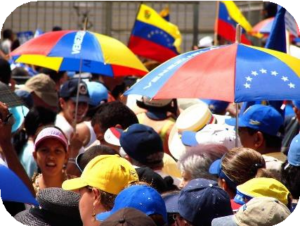 A crowd of people with umbrellas resembling the Venezuelan flag