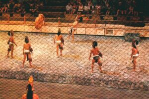 People in an arena playing a Mayan ball game