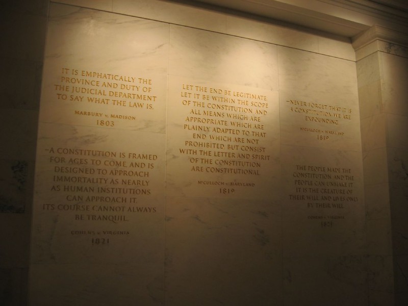 Stone wall engraved with quotes, notably an 1819 quote from McCulloch v. Maryland in the center.