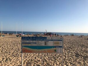 Beach with a sign that says "Playa de la Costilla"