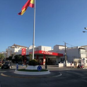 Gas Station behind a roundabout with Spanish flag