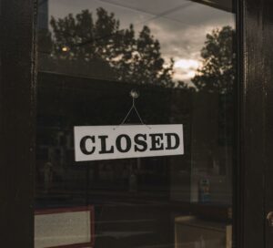 "Closed" sign on a glass door
