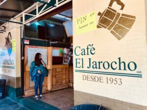 A photo of the outside brick of a building with "Café El Jarocho desde 1953" painted on the side.