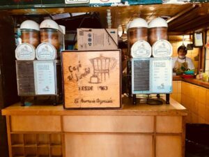 A photo of the coffee machines at Café El Jarocho sitting on a wooden counter.