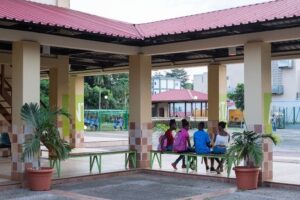 Four people sitting on a bench at the Centro Cultural