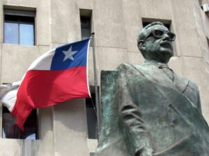 Salvador Allende statue next to a flag