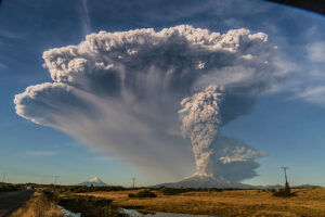 A volcano erupting high into the sky