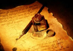 A fountain pen with a bottle of ink next to it