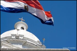 The Paraguayan flag flies near a church