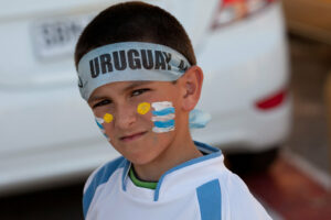 A kid with the flag of Uruguay painted on his cheeks