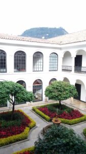 A garden courtyard with flowers and small trees