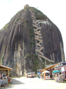 A large hill with a switchbacking staircase constructed into the edge