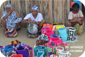 A woman making colorful bags to sell on the street