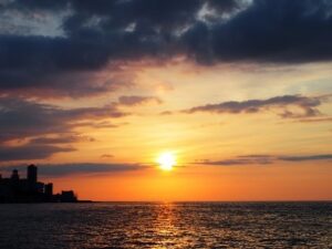 The sun setting over the ocean