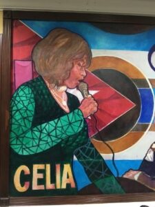 A mural of Celia Cruz singing into a microphone