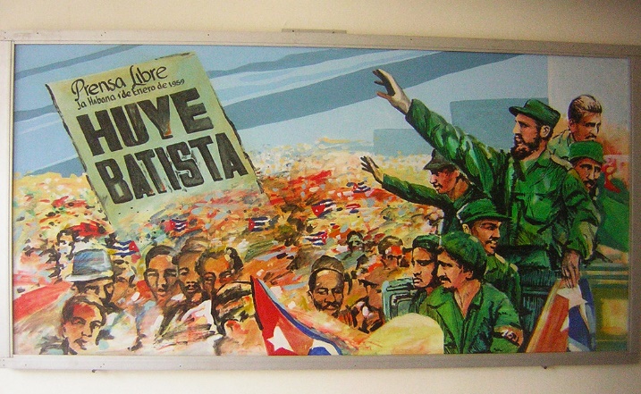 A Cuban propaganda painting, with Fidel Castro on one side and a sign saying, "Huye Batista" on the other