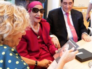 A woman holding the book, "The Art of Alicia Alonso"