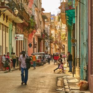 People walking down a busy Cuban street