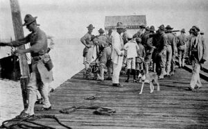 Soldiers on a dock in a black-and-white photo