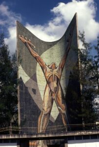 A mural of a nude man reaching toward the sky