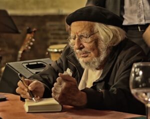Nicaraguan poet Ernesto Cardenal autographing a book