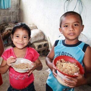 Two children holding bowls of food