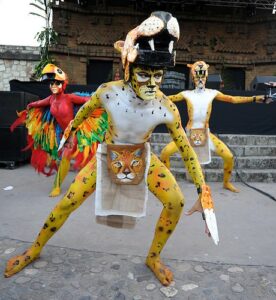 Actors in body paint and animal costumes.
