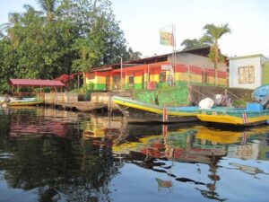 A colorful building and small boats on the water