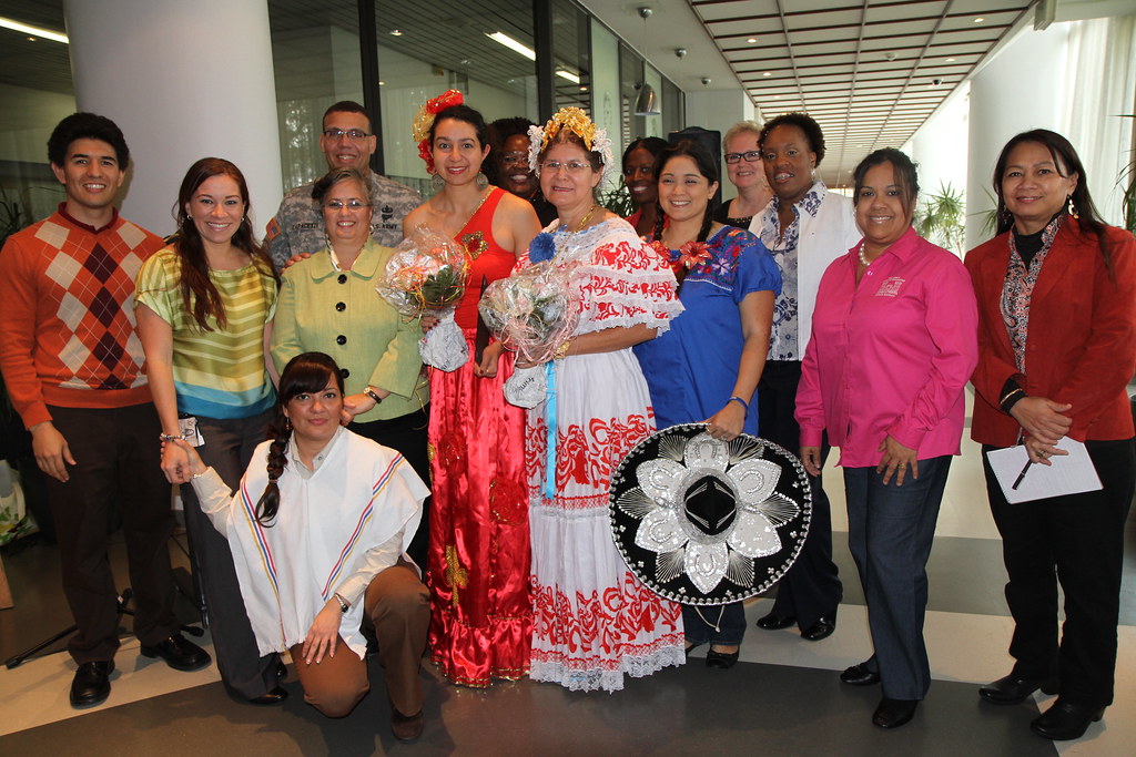 A photo of people smiling, some dressed in traditional outfits to celebrate Hispanic Heritage Month