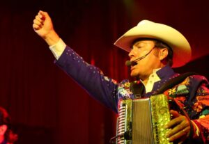A man playing an accordion on stage
