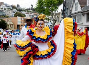 A woman dressed in a colorful traditional dress for a National Hispanic Heritage Month parade