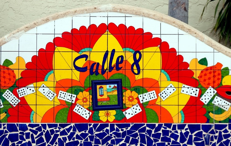 Painted tiles that read, "Calle 8" with flowers and dominos decorating the rest