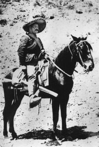 A black-and-white photo of Pancho Villa on horseback