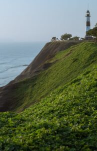 A lighthouse on the edge of a seaside cliff