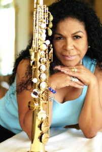 Eva Ayllon with a soprano saxophone