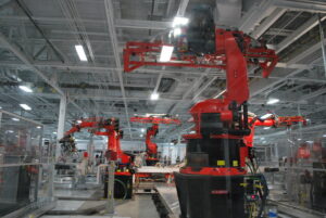 robots working in the tesla factory manufacturing line