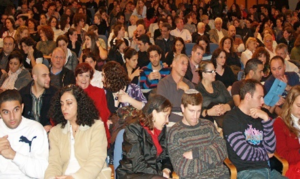 A crowd of people sitting in chairs.