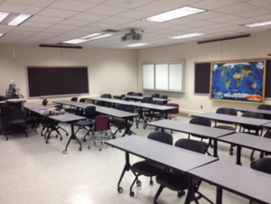 A classroom with tables and chairs.