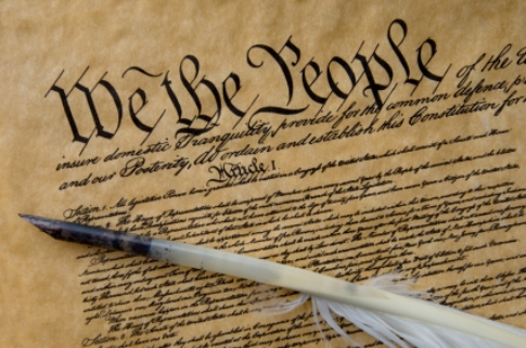 A picture of the constituion with the phrase "We the People" written in large letters.