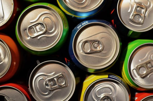 Photo looking down at the tops of several soda cans