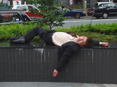 Drunk salary man sleeping outside