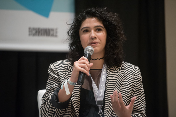 Woman speaking into a microphone