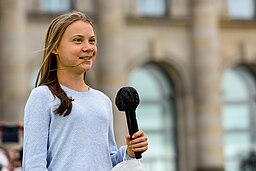 Thunberg speaking into a microphone