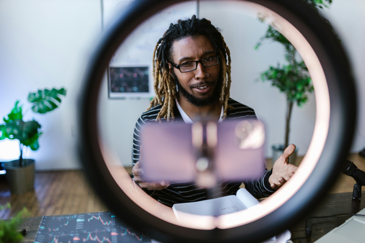 A man looks at a camera while recording himself