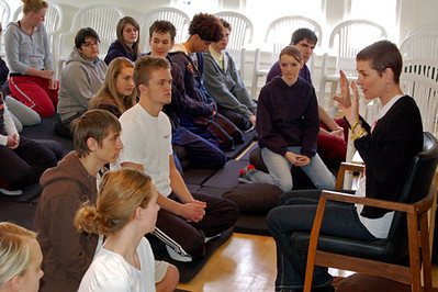 A teacher instructs students on meditation