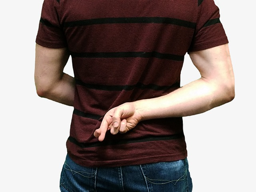 A person with their fingers crossed behind their back