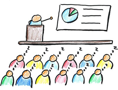 Cartoon of an audience asleep while the speaker points at a slide