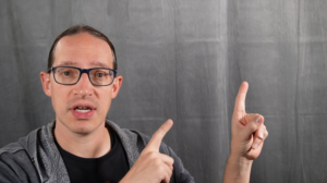 Picture of a man pointing to nothing on a blank screen