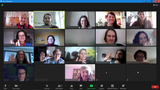 Computer screen showing Zoom attendants, and some ar raising their hands