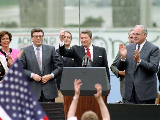 Ronald Reagan gives a thumbs behind a podium